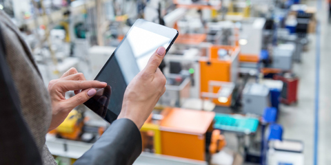 Woman using an ipad in a warehouse