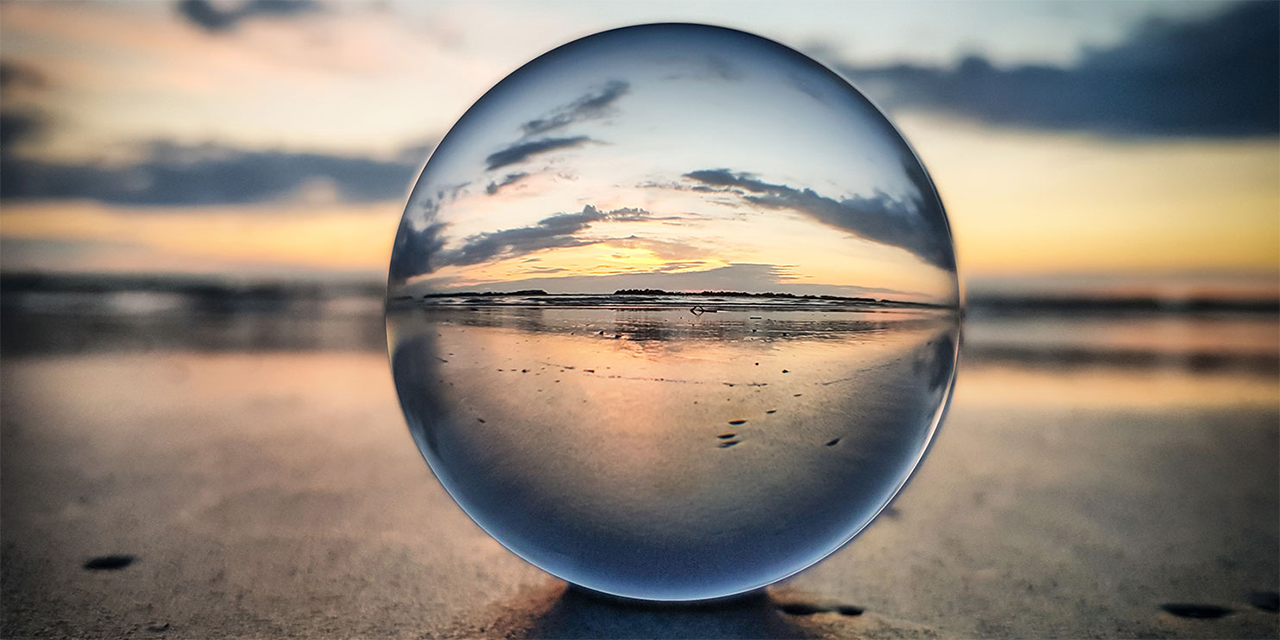 Beach viewed through a glass orb