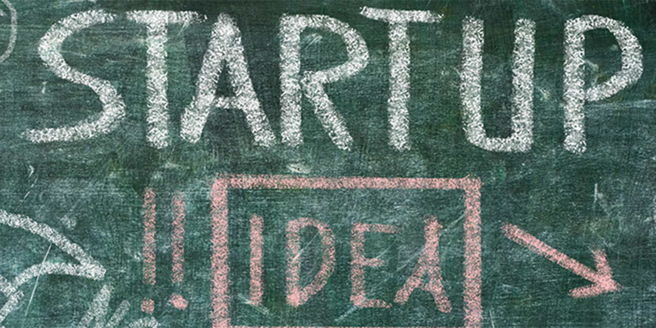 Chalkboard with the words 'startup' and 'idea' written on it.