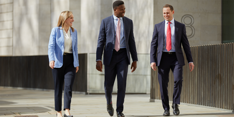 Baird private equity associates walking through a corridor.