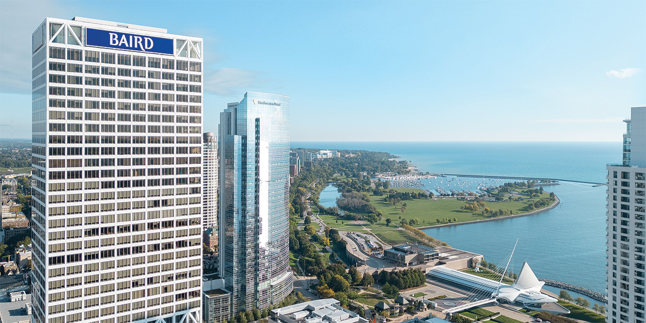 Baird signage atop U.S. Bank Center in the Milwaukee skyline overlooking Lake Michigan